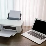 laptop-wooden-table-with-printer_1232-568