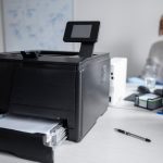 woman-talking-phone-work-printer_23-2149457029